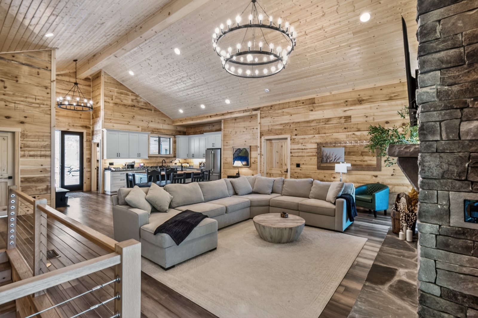 Great room with vaulted ceiling and stone fireplace