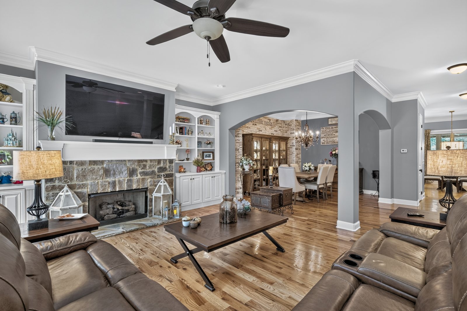 Living room with stone fireplace and built-ins